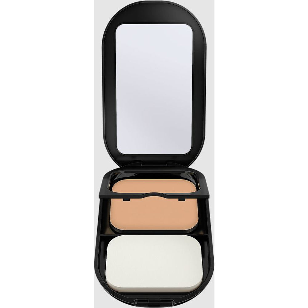 An open black makeup compact with a built-in mirror, showing a pressed powder in a warm light beige shade and a white puff applicator, set against a plain white background.