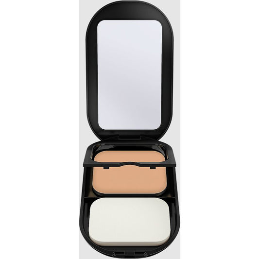 An open black makeup compact with a built-in mirror, showing a pressed powder in a warm light beige shade and a white puff applicator, set against a plain white background.