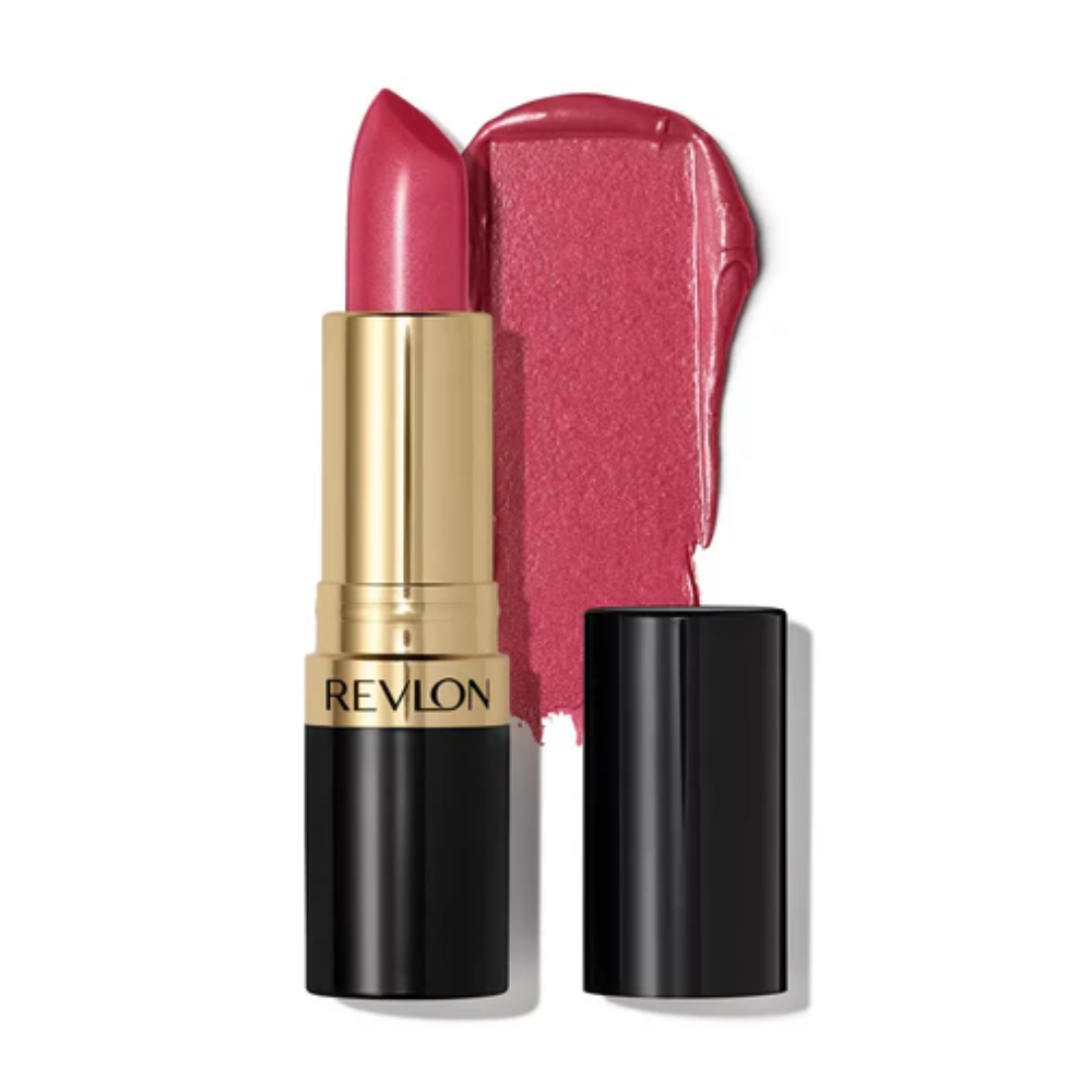 A Revlon lipstick in a metallic gold and black tube, shown with the cap off next to a textured smear of the pinkish-red lipstick on a white background.