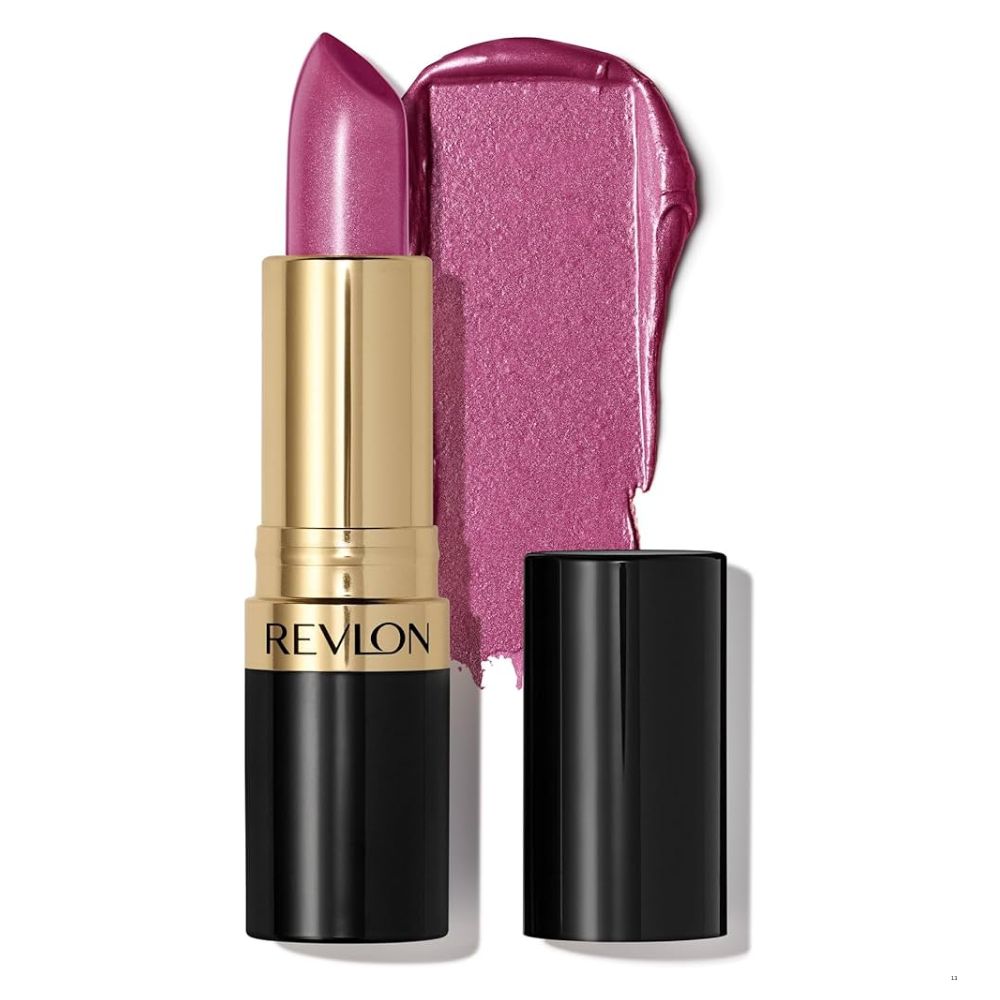 A Revlon lipstick in a metallic gold and black tube, shown with the cap off next to a glossy swatch of the pinkish-purple lipstick on a white background.